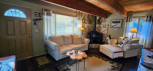 living room featuring wood ceiling, a wealth of natural light, beam ceiling, and a wood stove