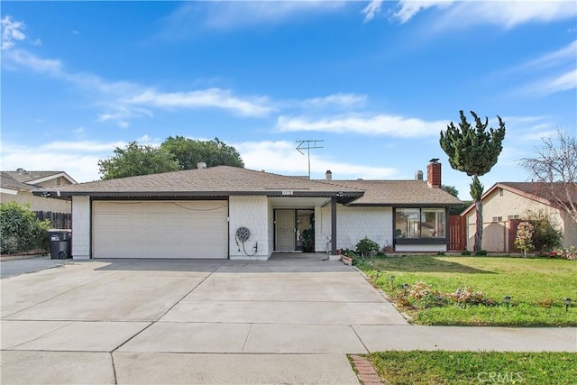 single story home featuring a garage and a front yard