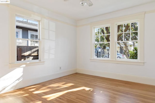 unfurnished room with wood-type flooring