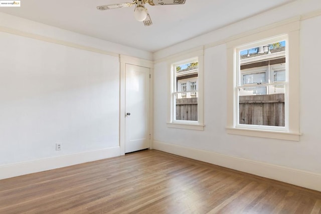 empty room featuring ceiling fan and hardwood / wood-style floors