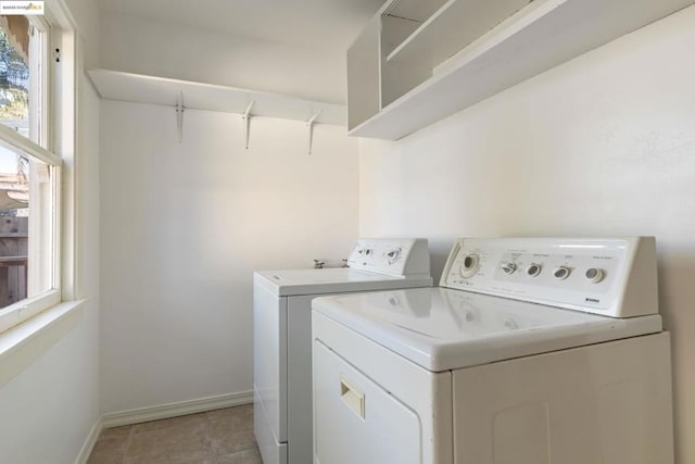 laundry area with washing machine and dryer and light tile patterned flooring