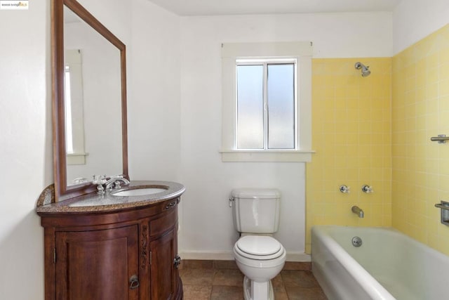 full bathroom featuring tile patterned floors, toilet, vanity, and tiled shower / bath combo