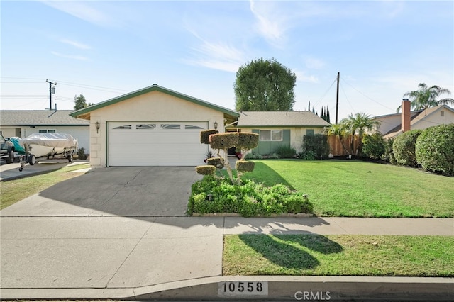 ranch-style home featuring a front lawn and a garage