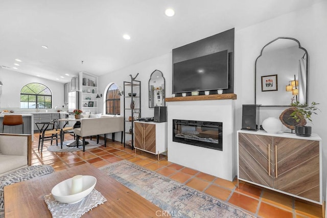 living room with tile patterned floors and vaulted ceiling