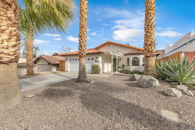 mediterranean / spanish-style home with a garage