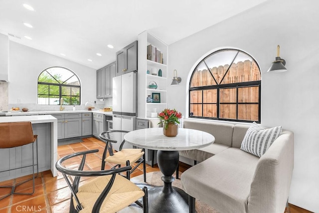 dining area featuring light tile patterned floors and sink