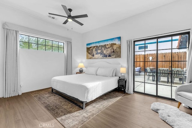 bedroom with ceiling fan, light hardwood / wood-style floors, and access to exterior