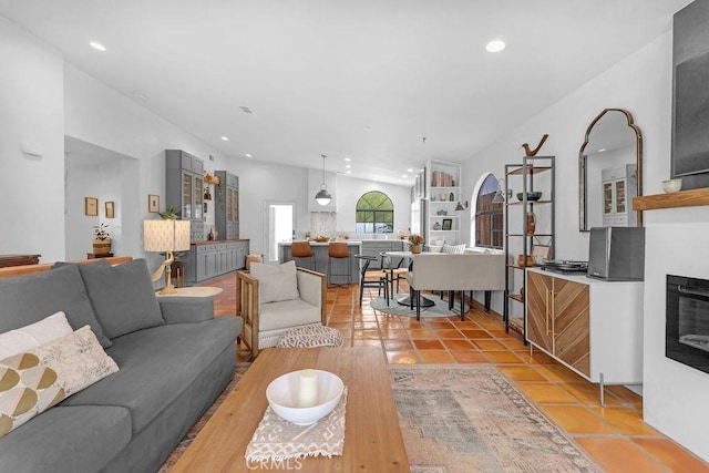 living room with light tile patterned floors and lofted ceiling