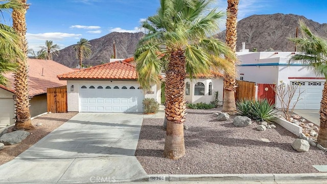 view of front of property featuring a mountain view and a garage