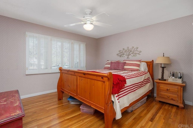 bedroom with ceiling fan and light hardwood / wood-style floors