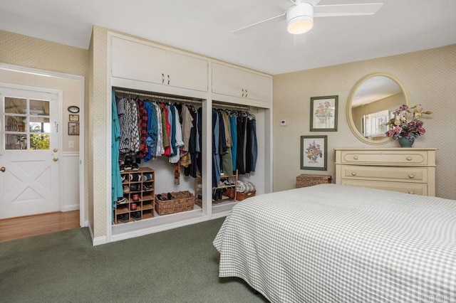 carpeted bedroom featuring ceiling fan and two closets