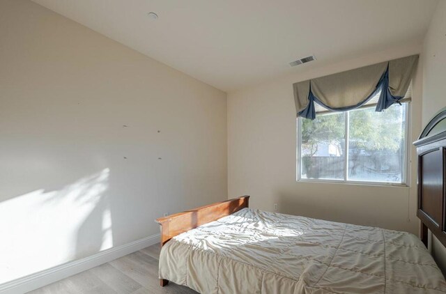 bedroom with light wood-type flooring