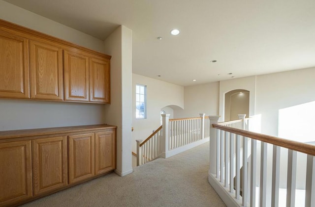 corridor with light colored carpet