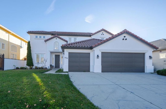 mediterranean / spanish-style home with a front yard and a garage