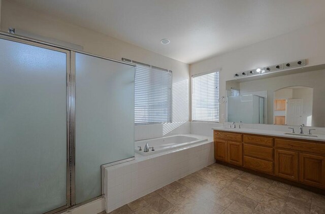 bathroom with plus walk in shower and vanity