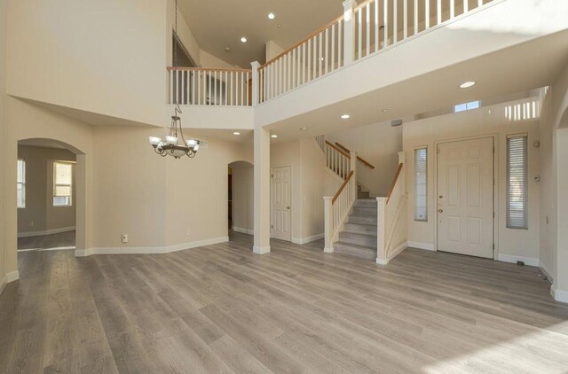 foyer featuring a notable chandelier, a high ceiling, and hardwood / wood-style flooring