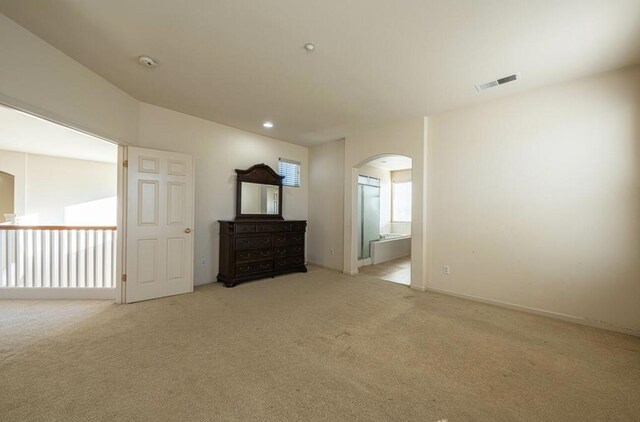 unfurnished room featuring light carpet