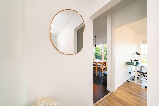 corridor with light hardwood / wood-style floors