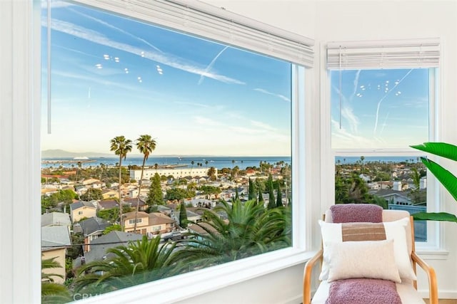 sunroom featuring a water view and a healthy amount of sunlight