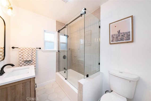 full bathroom featuring tile patterned floors, enclosed tub / shower combo, vanity, and toilet