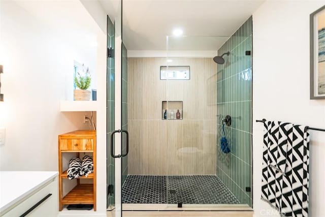 bathroom with an enclosed shower and vanity