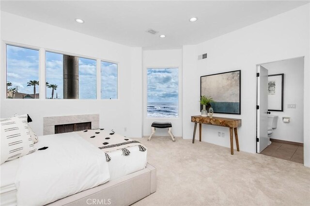 carpeted bedroom featuring ensuite bath