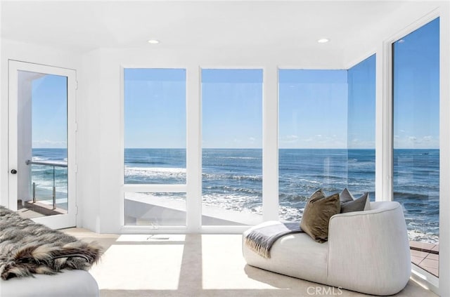 interior space featuring a beach view and a water view