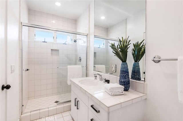 bathroom featuring vanity, tile patterned flooring, and walk in shower