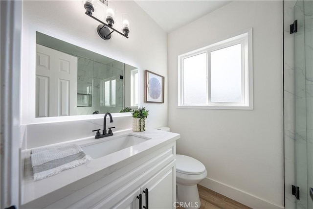 bathroom with hardwood / wood-style flooring, an enclosed shower, and vanity