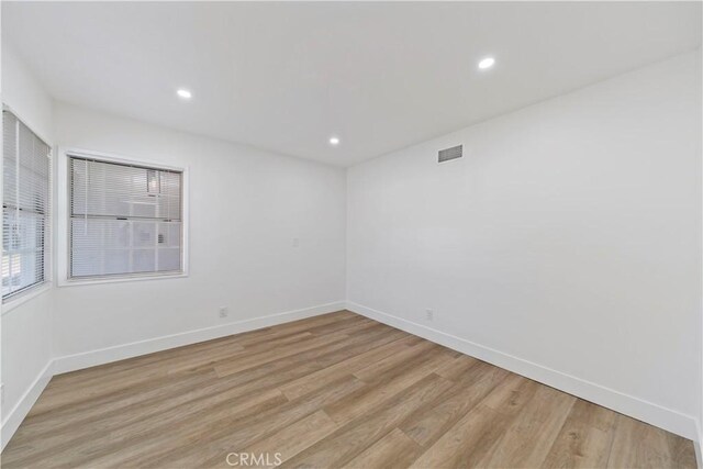 unfurnished room with light hardwood / wood-style floors