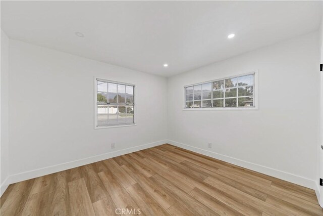 spare room with light hardwood / wood-style flooring