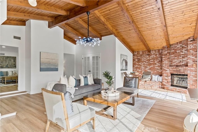 living room featuring wood ceiling, beam ceiling, light hardwood / wood-style floors, and a notable chandelier