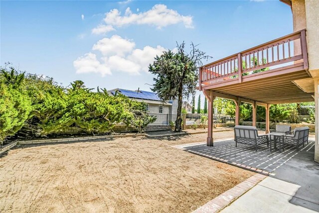 view of yard with a patio area, a wooden deck, and outdoor lounge area