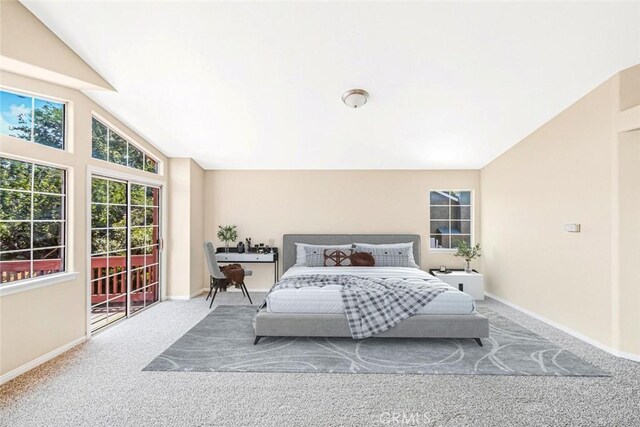 bedroom with carpet and lofted ceiling