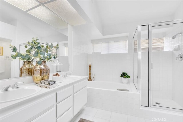 bathroom featuring tile patterned flooring, vanity, and shower with separate bathtub