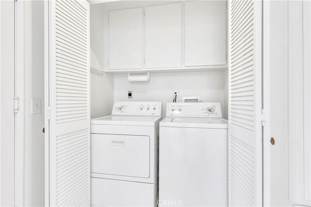 laundry area with cabinets and washing machine and dryer