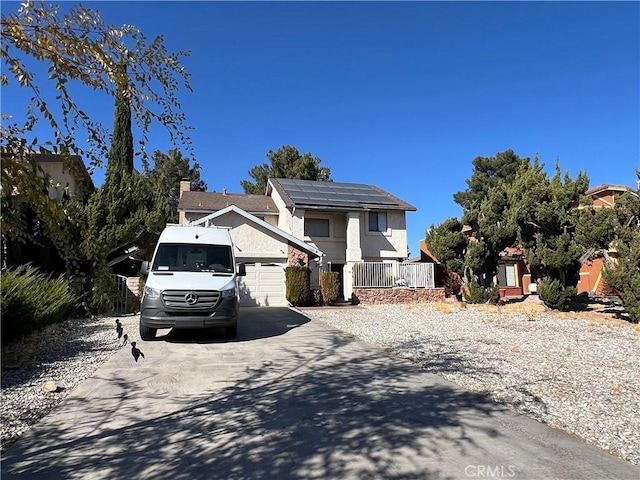 view of front of home featuring solar panels