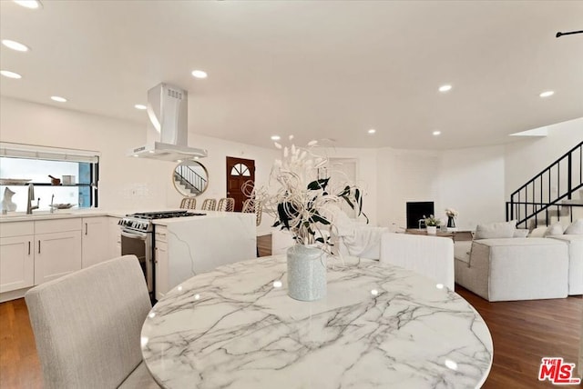 dining area with dark hardwood / wood-style floors and sink