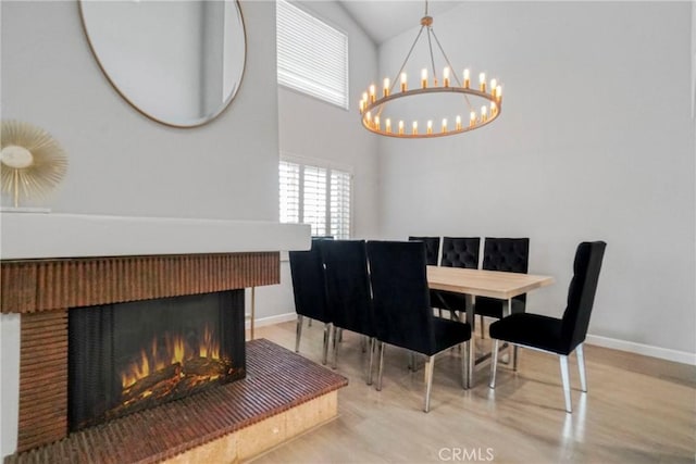 dining area with an inviting chandelier and light hardwood / wood-style floors