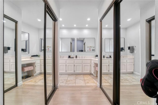 bathroom with hardwood / wood-style flooring and vanity