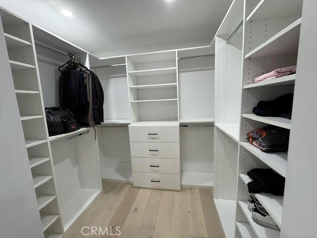 walk in closet featuring light hardwood / wood-style flooring