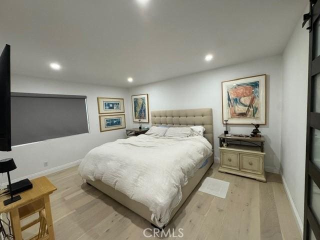 bedroom with light hardwood / wood-style floors