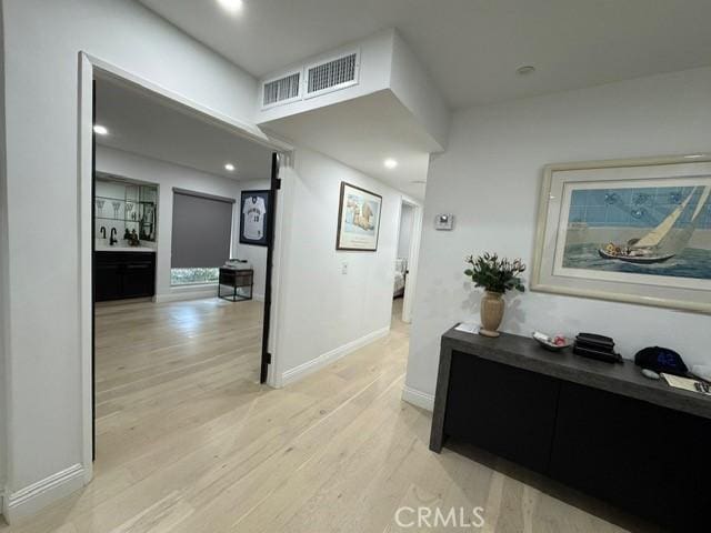 hallway with light hardwood / wood-style flooring