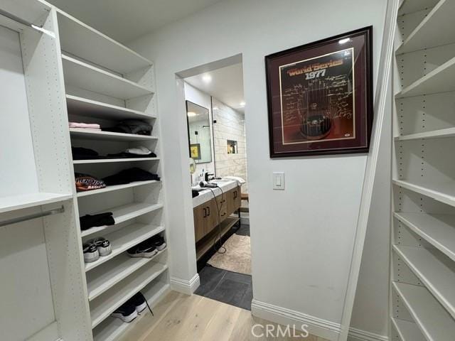 spacious closet featuring light hardwood / wood-style flooring