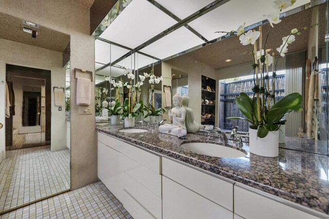 bathroom featuring tile patterned flooring and vanity