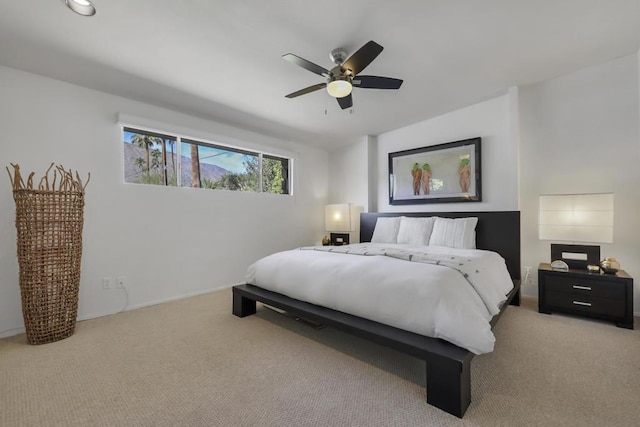 bedroom with ceiling fan and light colored carpet