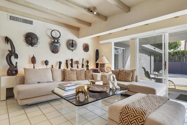 living room with beamed ceiling and light tile patterned flooring