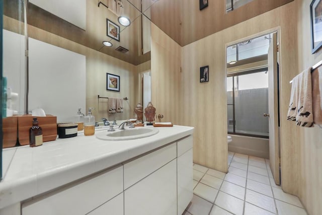 full bathroom featuring enclosed tub / shower combo, tile patterned flooring, a towering ceiling, and vanity