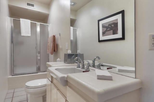 full bathroom with bath / shower combo with glass door, toilet, vanity, and tile patterned flooring