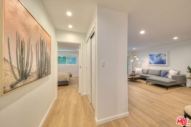 hall with light hardwood / wood-style flooring